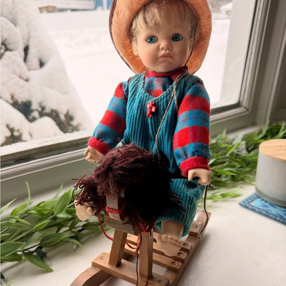 Doll in Striped Outfit on Rocking Horse